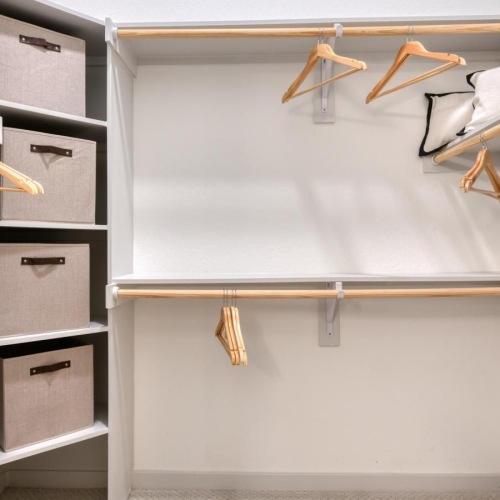 a white wall with a shelf and a white wall with a white door