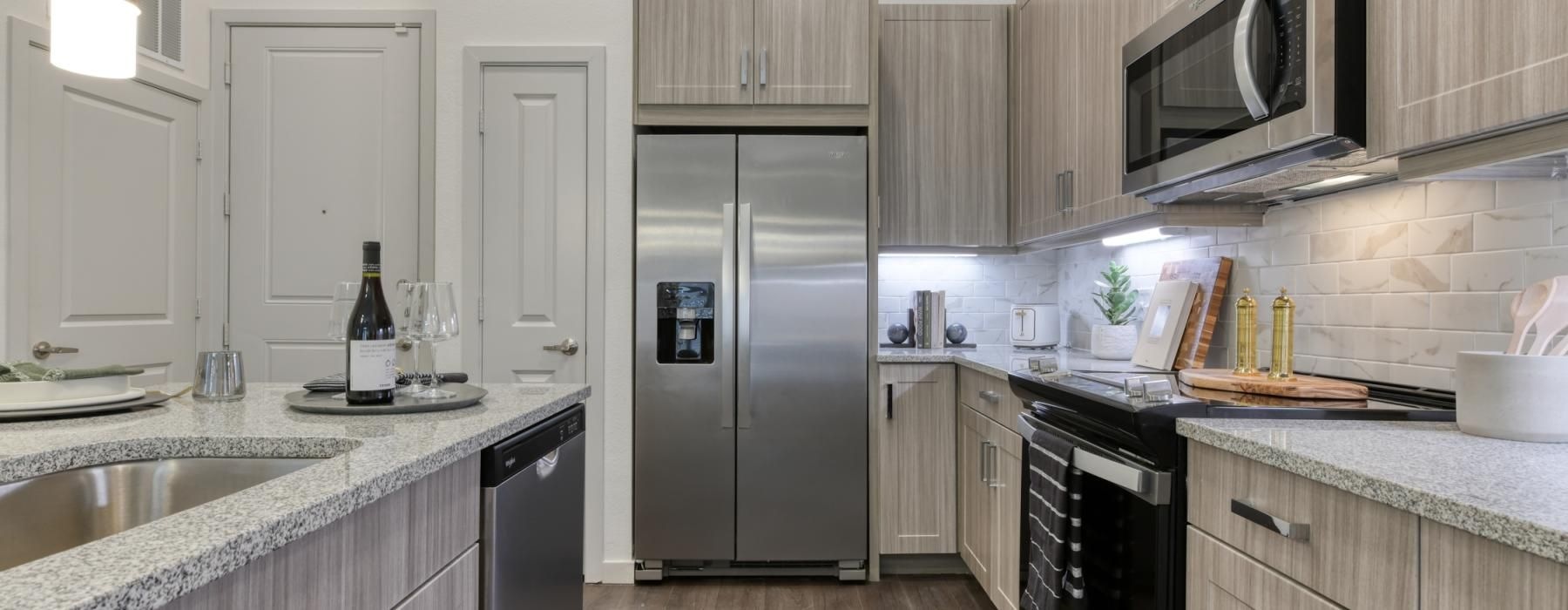 a kitchen with a stainless steel refrigerator
