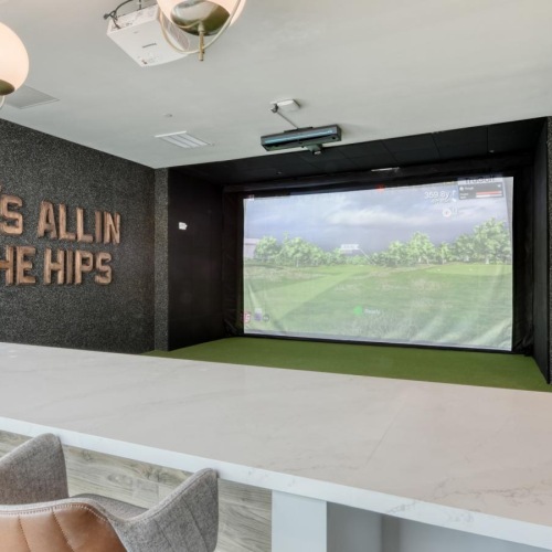 a large room with a large screen and chairs